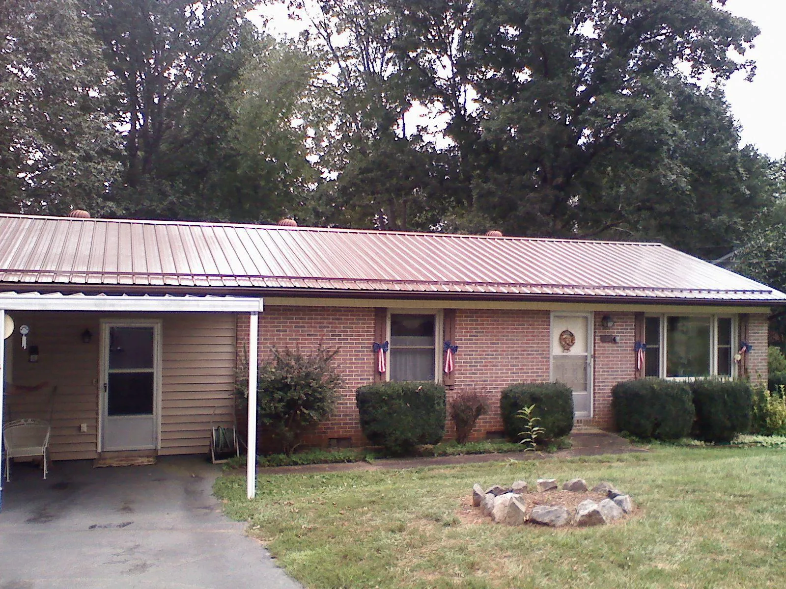 Bronze metal roof and carport on a brick ranch home — Roof Repair work by our crew in Eden